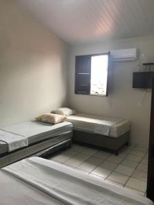 塞古罗港Pousadinha- Melhor Localização的带窗户的客房内的两张床
