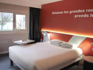 博韦博韦宜必思尚品酒店的一间卧室设有一张大床和红色的墙壁