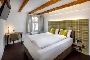 韦齐孔施维泽霍夫酒店的一间卧室配有一张大床和一张书桌