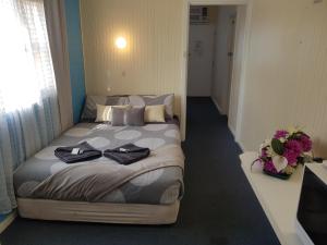 怀阿拉怀阿拉乡村汽车旅馆的一间卧室配有一张床,上面有两条毛巾