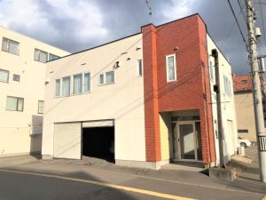 旭川STAY3‐11的白色和红色的建筑,设有车库