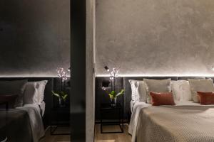 佩斯卡拉Corso 84 Luxury Suites的带枕头的三张床客房