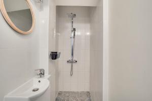 塞纳河畔伊夫里Appartement charmant entièrement équipé的带淋浴、卫生间和镜子的浴室