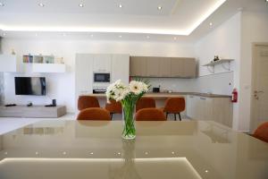 泽布季3-bedroom Apartment with views in Iz-Zebbug, Gozo的厨房里玻璃桌上的花瓶