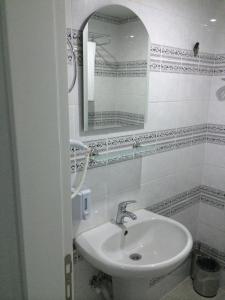 安塔利亚Mutado Hotel的白色的浴室设有水槽和镜子