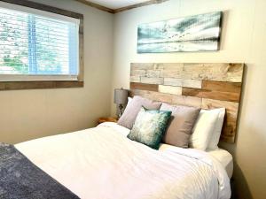GraylandArena del Mar的卧室配有白色的床和木制床头板