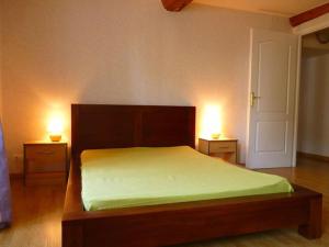 Bény-sur-Mer全面翻修5人老屋的一间卧室配有一张带两个台灯的床,