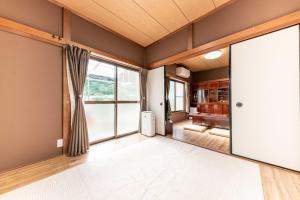箱根箱根湯本 川風荘 - Hakone Yumoto Kawakazesou的空客厅,带大推拉门