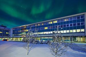 雷克雅未克Reykjavik Natura - Berjaya Iceland Hotels的天空中光明的办公楼