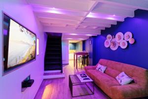 勒阿弗尔Romance spa tropical Le Havre的紫色的客厅配有沙发和桌子