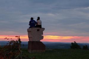 魏申费尔德Limerhof的两人坐在日落时分的石雕上
