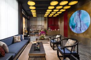 广州广州永庆坊瞻云精选酒店的客厅配有蓝色的沙发和椅子