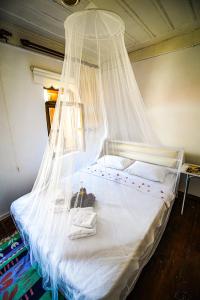 恰纳卡莱Grape Island Bozcaada Guest House的一间卧室配有一张带蚊帐的床