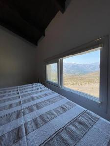 塔菲德尔瓦勒Hermosa casa en Tafí del Valle!的一间卧室设有一张床和一个大窗户