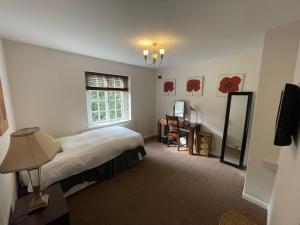 内尔斯沃思Garden House的一间卧室设有一张床和一个窗口
