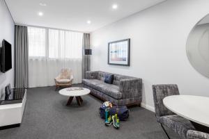 悉尼悉尼北部美利通公寓式酒店的客厅配有沙发和桌子