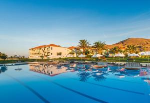 斯卡拉埃雷索Aeolian Village Beach Resort的一个带椅子和遮阳伞的大型游泳池