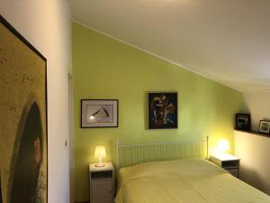 波雷奇Family Rooms Sabrina的一间卧室设有绿色的墙壁和一张带两盏灯的床。
