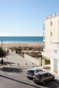 卡斯特尔德费尔斯Beach Castelldefels的两辆汽车停在海滩旁的停车场