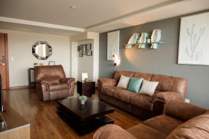 里奥班巴Wanderlot - Departamento Leganza - Penthouse Lujoso的客厅配有2张棕色沙发和1张桌子