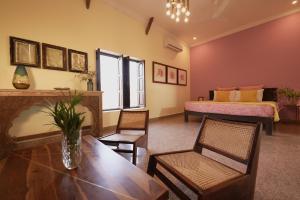 ShaitrāwaKaner Retreat - India's First Desert Botanical Resort的客厅配有桌椅和1张床