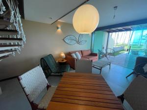 普拉亚多斯卡内罗斯卡尔内鲁斯海滩旅馆的客厅配有木桌和椅子