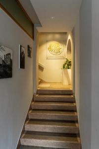 马尼亚戈Albergo Leon D'Oro的走廊上设有楼梯,墙上挂有绘画作品