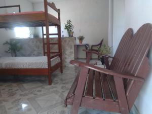 索雷Hostel Viajante Marajo的客房设有一张双层床和一把摇椅。