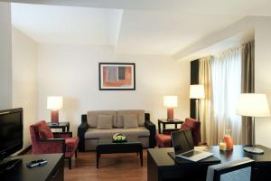 蒂米什瓦拉蒂米什瓦拉NH酒店的客厅配有沙发和桌子