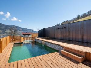 SchattbergApartment Mooslehen-1 by Interhome的一个带木制甲板和泳池景的游泳池