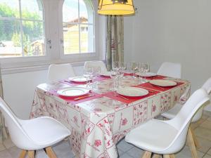 采尔马特Apartment Obri Tuftra-7 by Interhome的一张桌子、白色椅子和红白色的桌布
