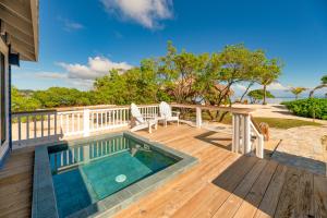 罗阿坦Barefoot Cay Resort的房屋顶部带游泳池的甲板