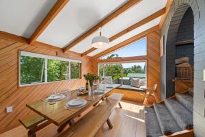 陶波Choice Wharewaka - Taupo Holiday Home的一间带桌子和一些窗户的用餐室