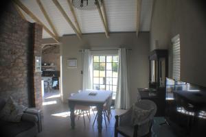 蒙塔古Pecan Tree Cottage的客厅配有桌椅和窗户。