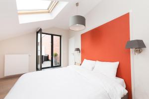 列日Smartflats Design - Opera的卧室配有白色的床和橙色的墙
