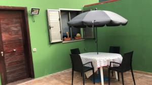 特尔德Casa Alisios的一张桌子和椅子,一把伞放在房间里