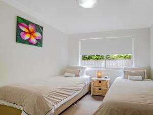 凯阿玛Kiama Sunrise Kiama的白色客房的两张床,设有窗户