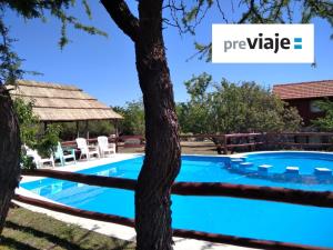 梅洛Cabañas Yanasuy的一座游泳池,上面有一棵树和一个私人阅读标志