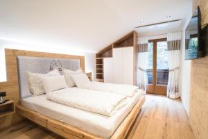 Sankt Jodok am BrennerFerienhaus Leite Häusl的一间卧室配有一张大床和木制床头板