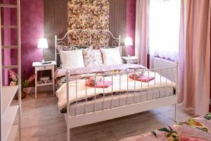 Česká VesPenzion Swist的一间卧室配有一张粉红色墙壁的床