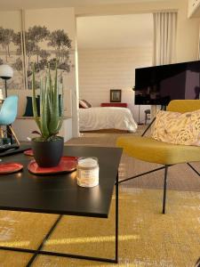 滨海图维列Appartement de standing vue mer 63 m2的客厅配有沙发和带仙人掌的桌子