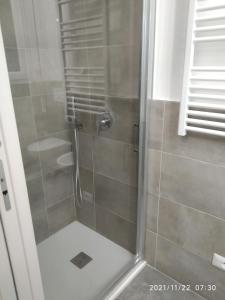 雷诺河畔卡萨莱基奥Poema Apartment的浴室里设有玻璃门淋浴