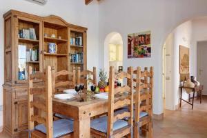 桑特柳伊斯Luxury Villa in Binibeca with Jacuzzi的一间带木桌和椅子的用餐室