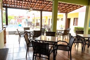 塞古罗港Condomínio Golden Goes的庭院内的餐厅,配有桌椅