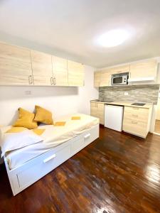 布勒伊-切尔维尼亚Luna's Cozy Apartment, skiin skiout in centre CIR 17的一间带白色床的卧室和一间厨房