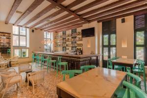 卡塔赫纳Charleston Santa Teresa Cartagena的一间设有绿色椅子的餐厅和一间酒吧
