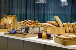 加勒穆恩奥斯陆机场斯堪迪克酒店的一张桌子上面有很多不同类型的面包