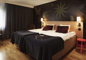 乌普兰斯韦斯比斯堪迪克乌普兰斯韦斯比酒店的一间卧室设有一张大床和黑色墙壁