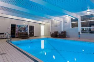 希尔科内斯希尔科内斯斯堪迪克酒店的一座大型游泳池拥有蓝色的天花板