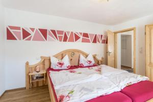 米滕瓦尔德Ferienwohnung Granat的卧室配有一张带粉红色枕头的大床